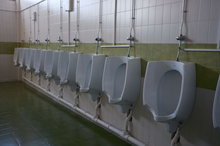 A row of urinals in a commercial washroom
