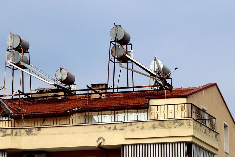 Solar water heaters and their collectors on a house roof